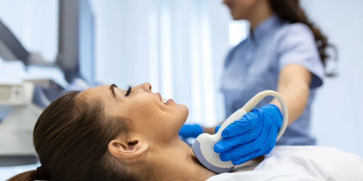 Woman receiving thyroid diagnostics for thyrotoxicosis and hypothyroidism