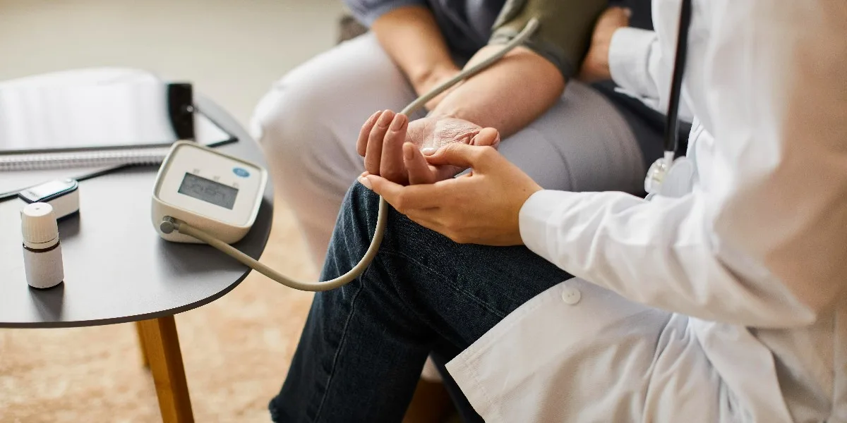 doctor checking the blood pressure for hypertension