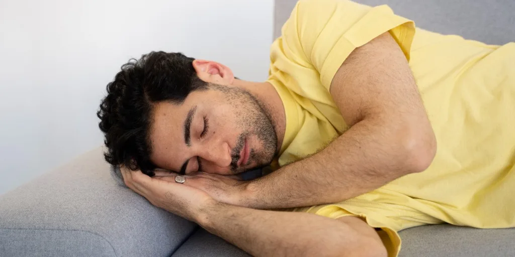 man sleeping on couch